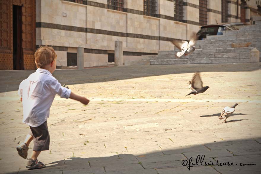traveling with young children - chasing pigeons in Italy