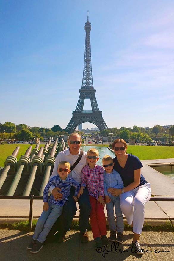 Family with three young kids traveling in Paris