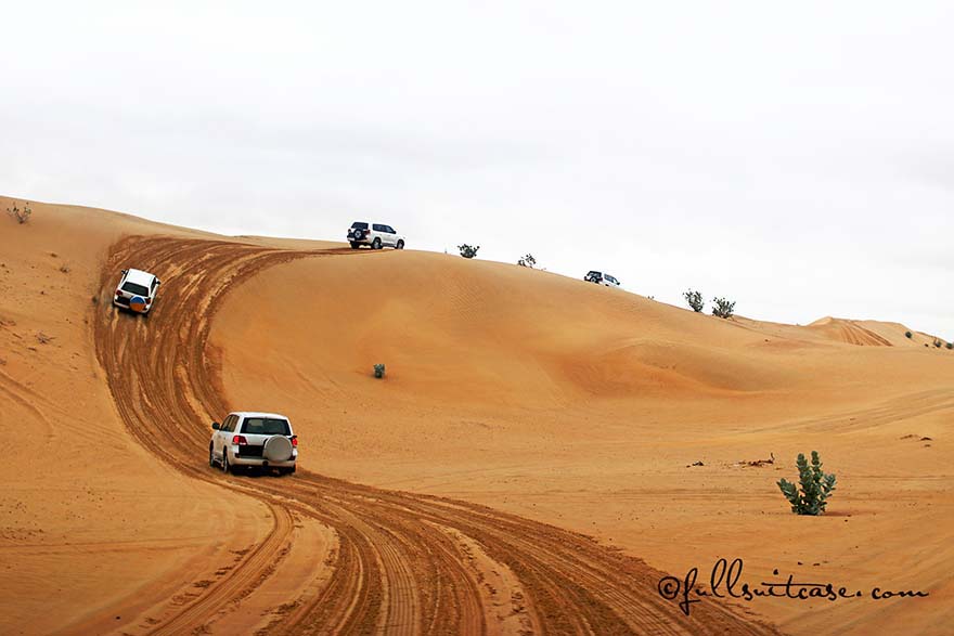 Group of 4x4 vehicles driving in a desert in Dubai