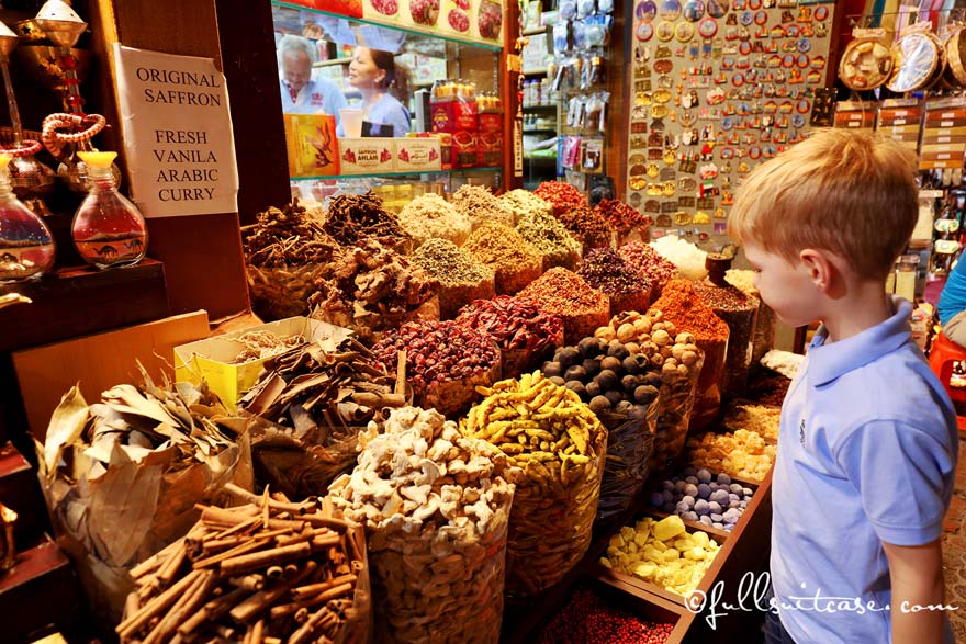 Boy tourist at the spice stand in Dubai Spice Souk in Deira