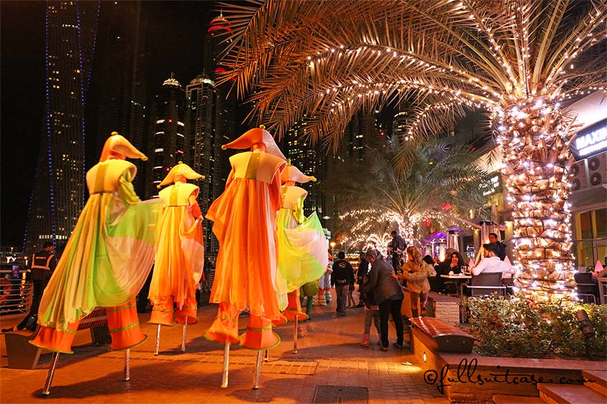 Dubai Marina Festive Parade with street performers walking on stilts