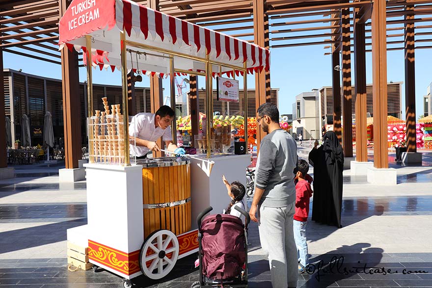 Arabic family at a Turkish ice cream stand on The Walk in Dubai