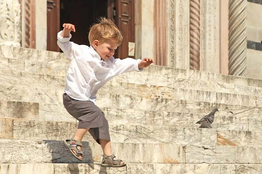 Child playing in an Italian city in summer