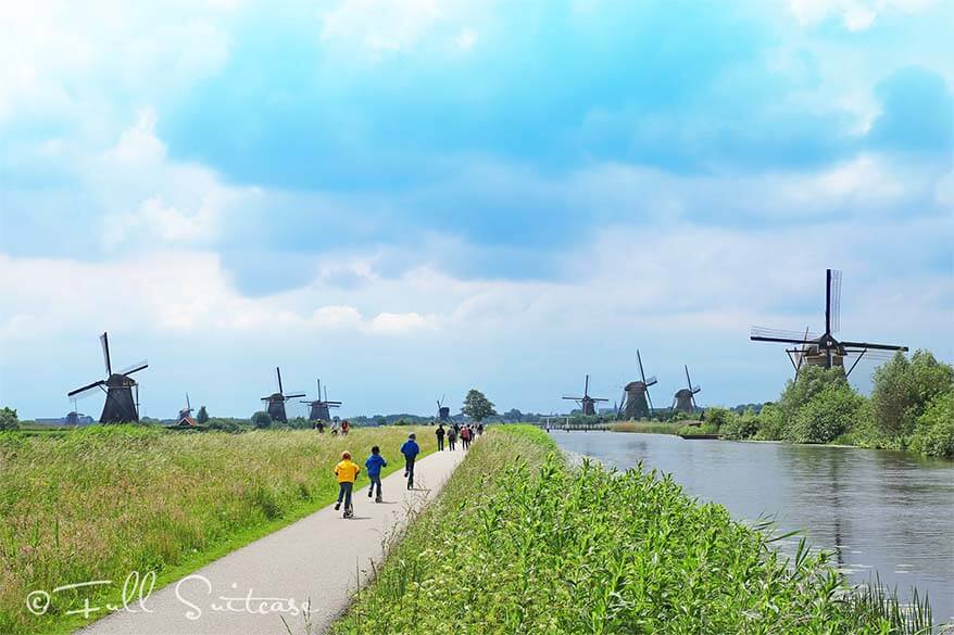 Kids exploring Kinderdijk by kick scooters