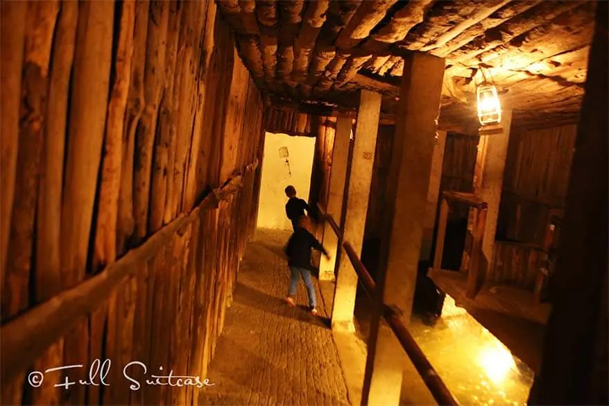 Kids walking through a sloping room inside the Citadel of Dinant