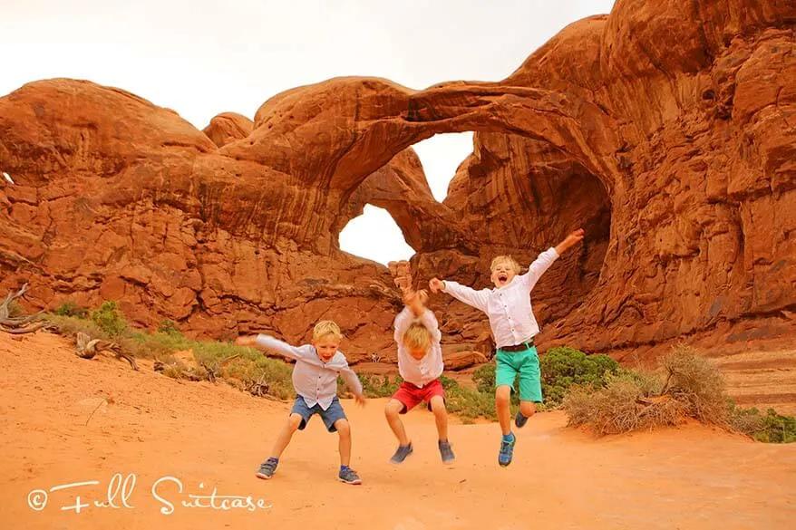 Jumping for a picture at the Double O Arch in Arches NP, USA