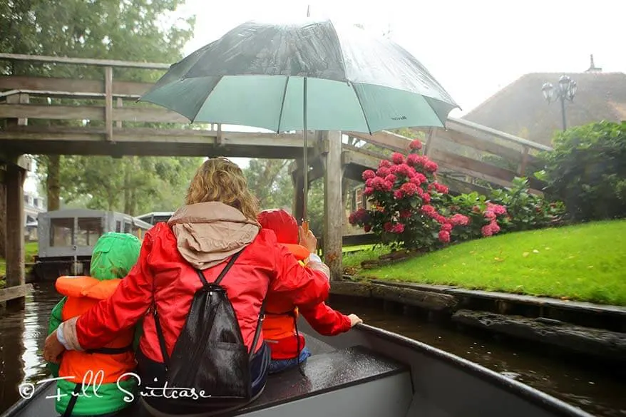 Riding a boat in the rain in Giethoorn Netherlands