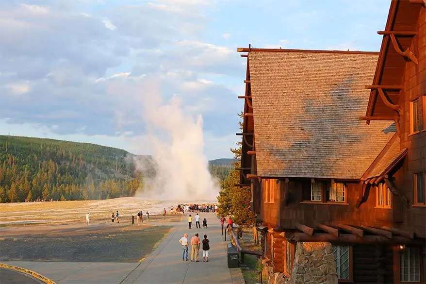 Old Faithful Inn and Geyser in Yellowstone National Park