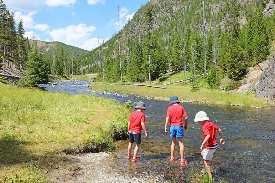 Kids playing in Gardner river in Yellowstone in summer