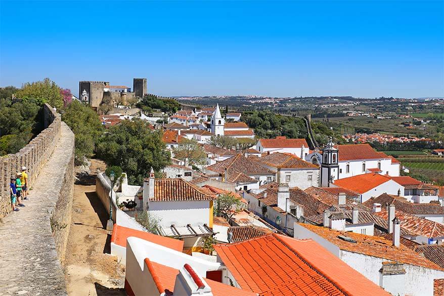 Kids walking on the city walls of Obidos in Portugal