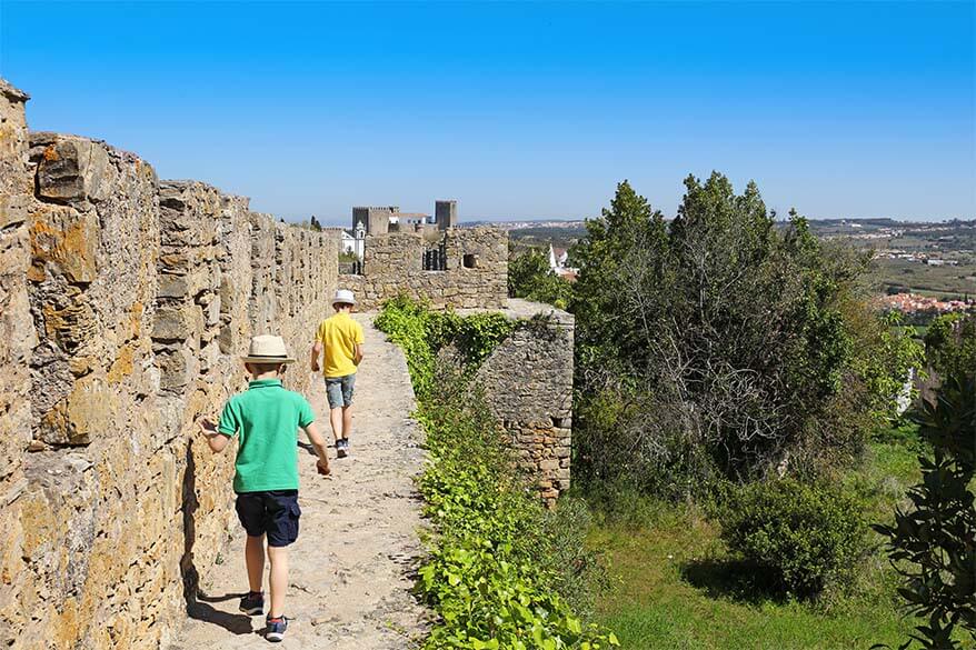Walking on the city walls of Obidos in Portugal with kids