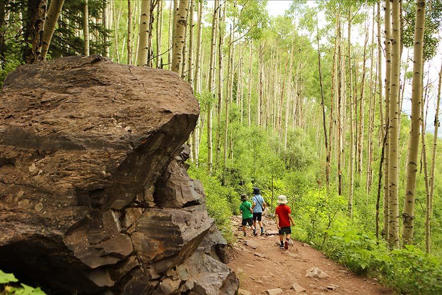 Hiking through the aspen forest on the Crater Lake Trail at Maroon Bells with kids