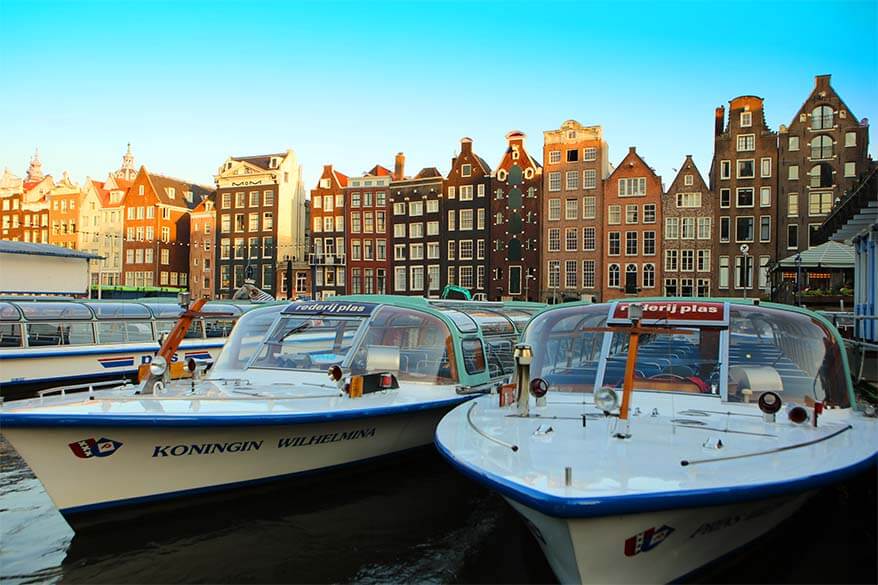 Damrak boats and historic buildings in Amsterdam