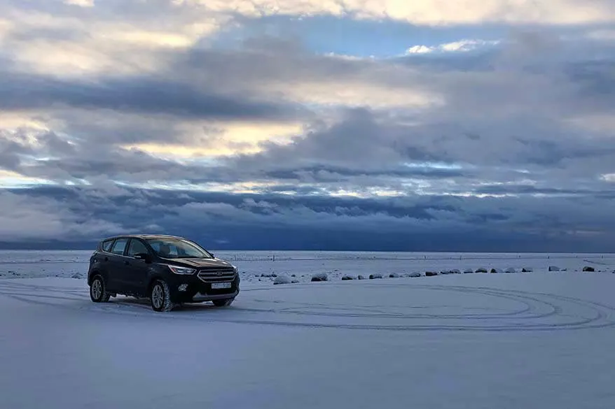 4WD vehicle at an empty parking lot covered with snow - driving Iceland's South Coast in winter