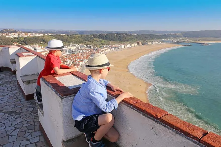 Kids looking at the view of Miradouro do Suberco in O Sitio district of Nazare Portugal