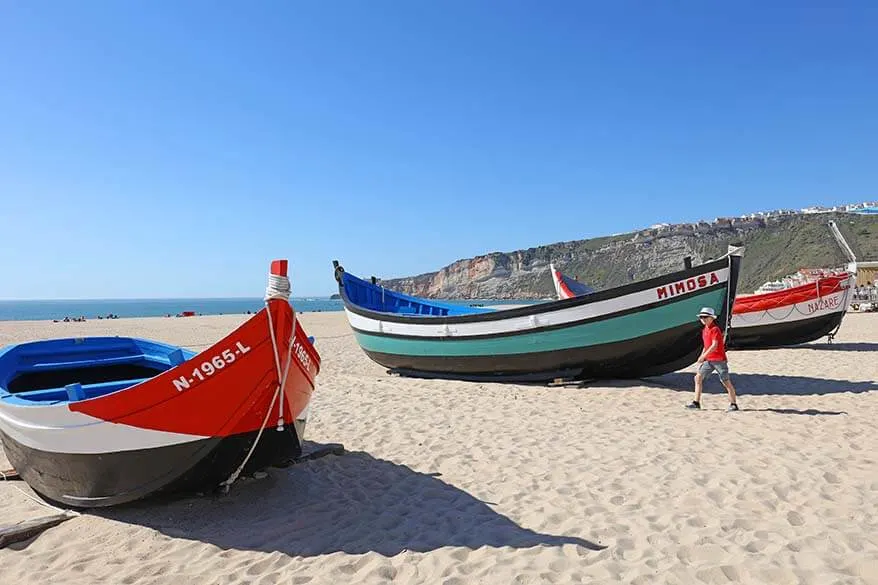 Traditional wooden fishing boats on a beach in Nazare Portugal