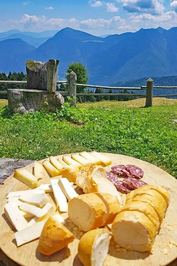 A plate of cheese, bread, and meat at a local dairy farm in Trentino mountains Italy