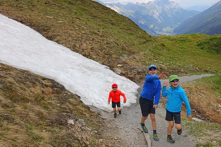 Kids playing - a snowball fight in Austrian Alps in summer