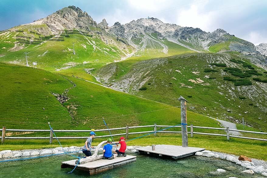 Kids playing at a water playground along the Mutspuren trail in St Anton in Tirol