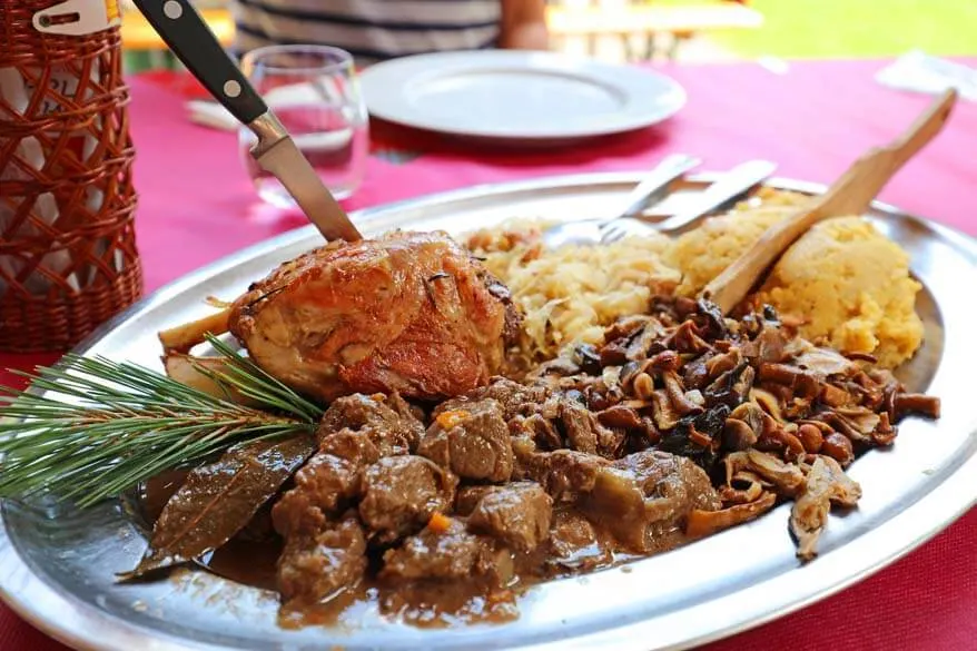 Traditional dish with meat, mushrooms, and polenta in Trentino Italy