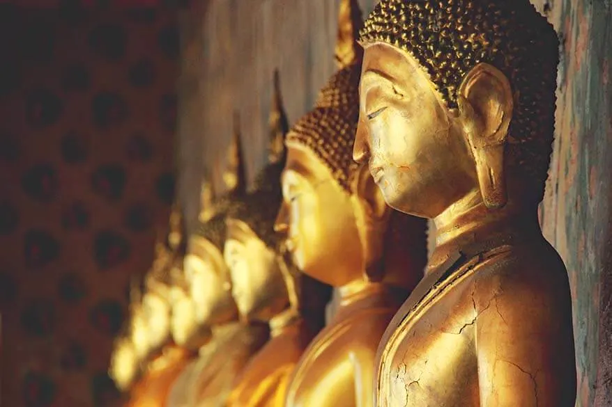 Row of golden Buddha statues at Wat Arun temple in Bangkok Thailand