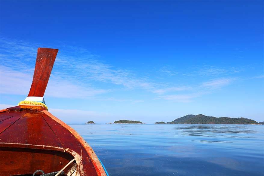 Wooden Thai longtail boat and azure blue sea - Phuket island hopping in Andaman sea