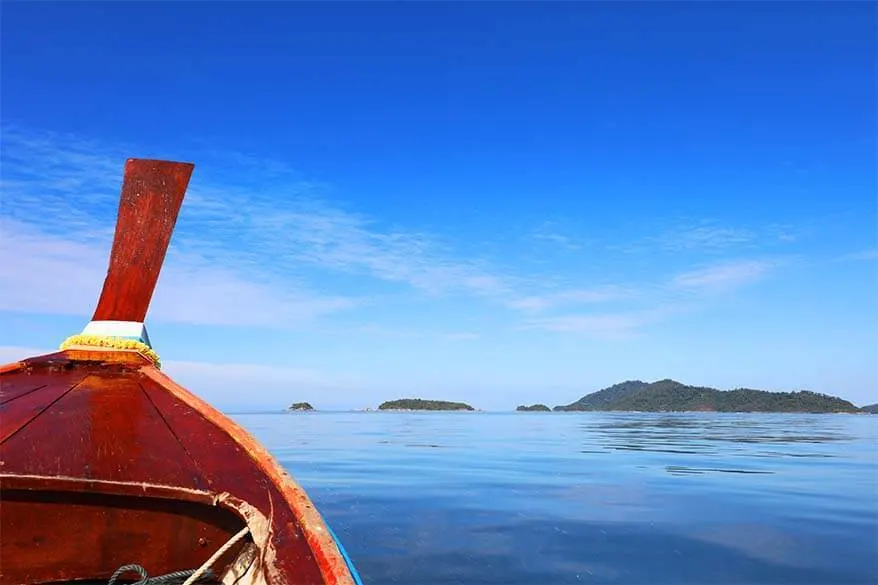 Wooden Thai longtail boat and azure blue sea - Phuket island hopping in Andaman sea