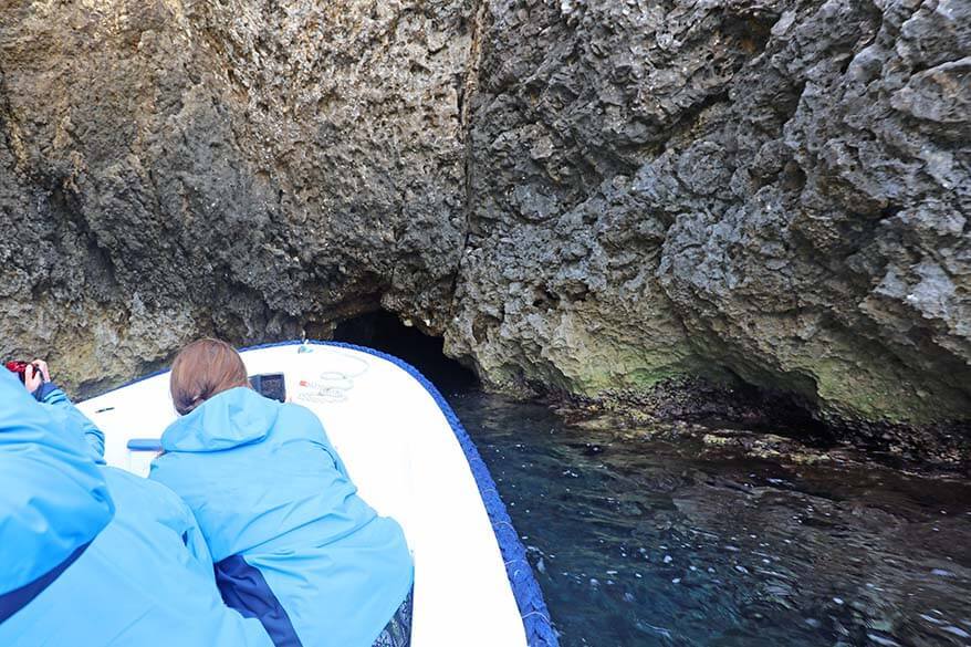 Boat entering the narrow opening of the Blue Cave in Croatia