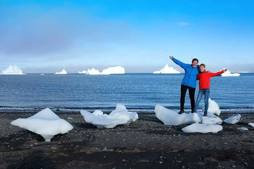 Family trip to Greenland - icebergs on a black sand beach on Disko Island