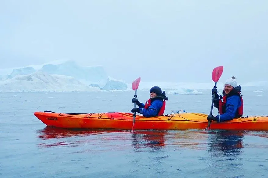 Kayaking between icebergs in Greenland