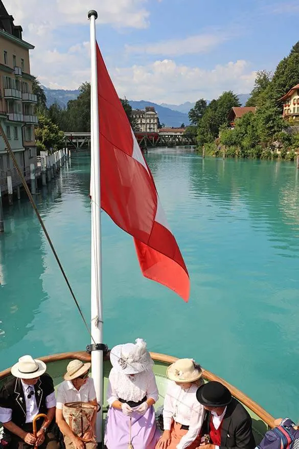 People in Belle-Epoque style clothing on a historic boat on Lake Brienz in Interlaken Switzerland