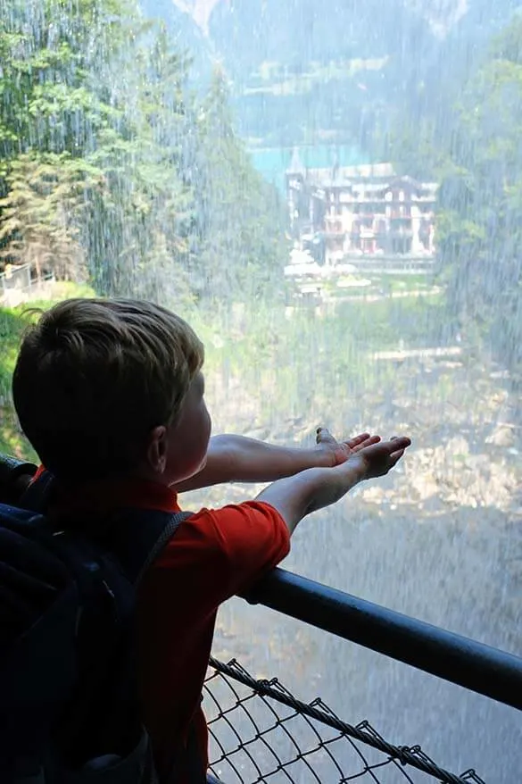 Standing behind Giessbach waterfalls overlooking Grandhotel Giessbach and Lake Brienz - Switzerland