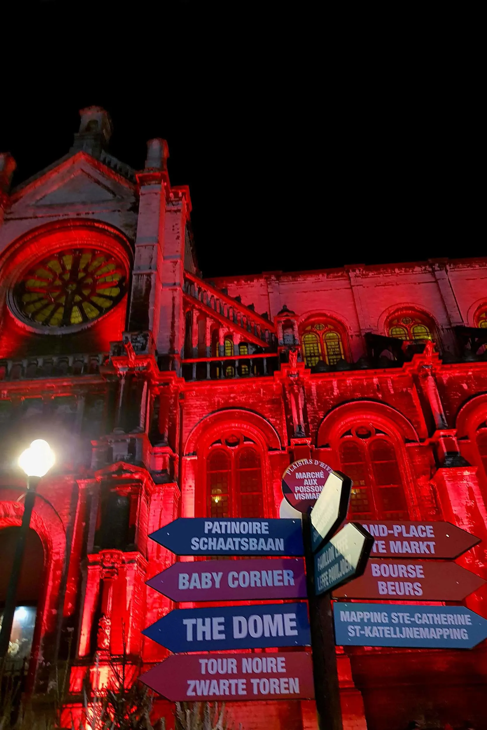 Christmas market informational signs and arrows at the Saint Catherine Church in Brussels