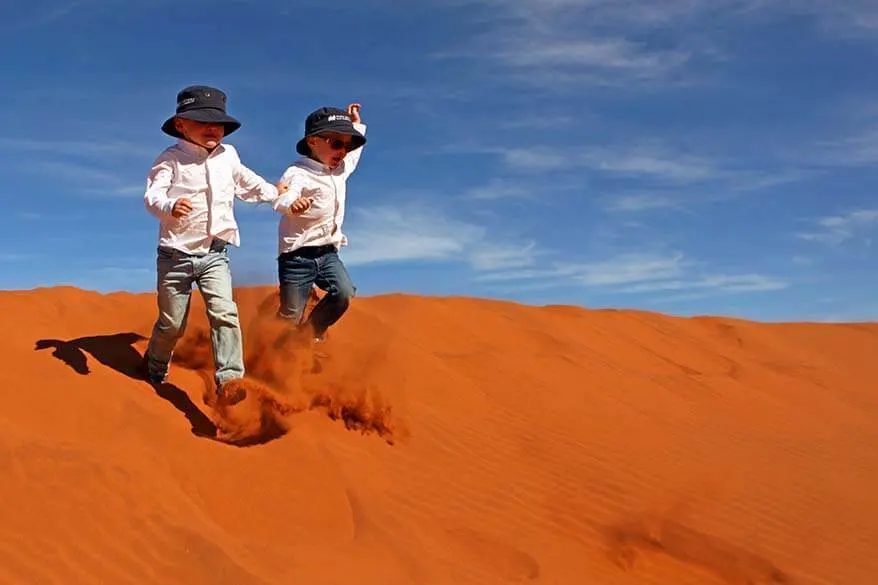 Kids running down the sand dunes in Sossusvlei in Namibia