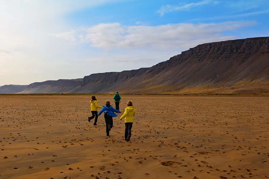 Walking on Raudasandur beach with kids