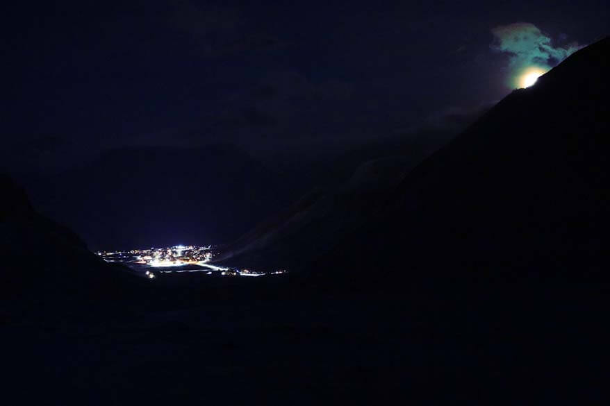 Longyearbyen town as seen from a nearby mountain during a snowmobile tour at night