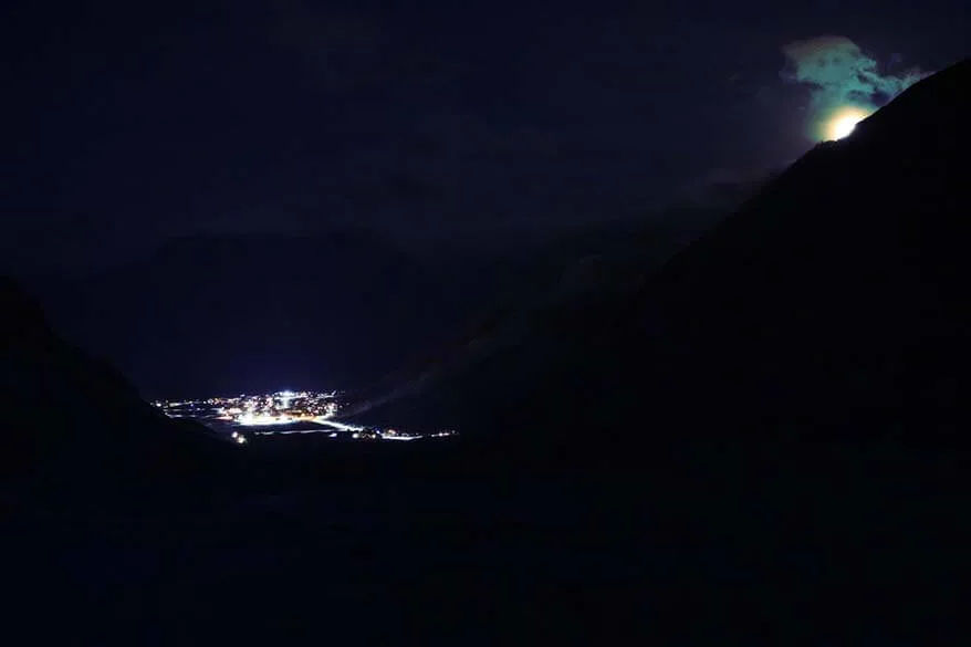 Longyearbyen town as seen from a nearby mountain during a snowmobile tour at night