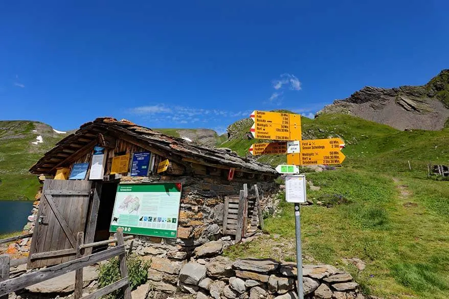 Mountain hut and hiking trail informational signs at Bachalpsee in Switzerland
