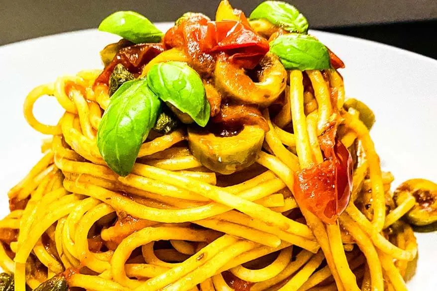 Spaghetti alla puttanesca - traditional dish from Campania region in Italy