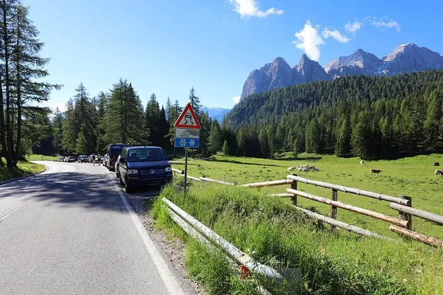 Cars parked on the street at Lago di Sorapis hike trailhead at Passo Tre Croci