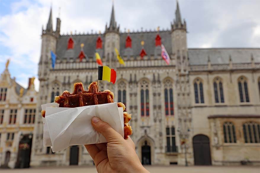 Belgian waffle with Bruges City Hall in the background