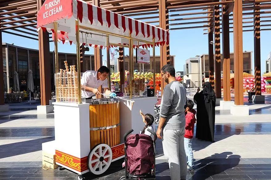 Family at Turkish ice cream stand on The Walk in Dubai