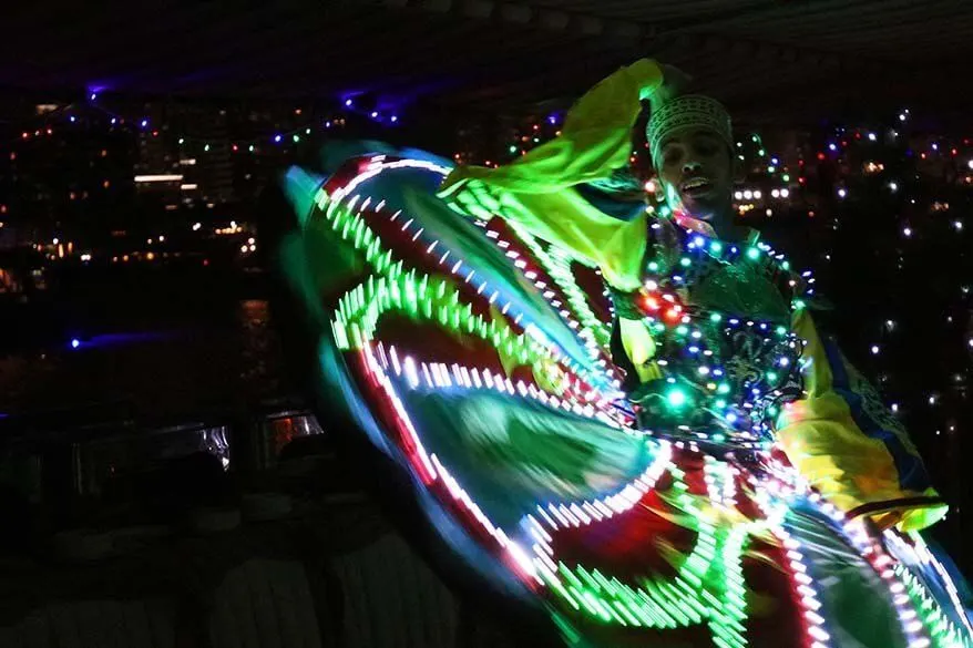 Tanoura dance performance with a skirt lit in the dark in Dubai