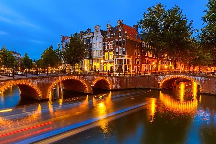 Amsterdam canals lit in the evening