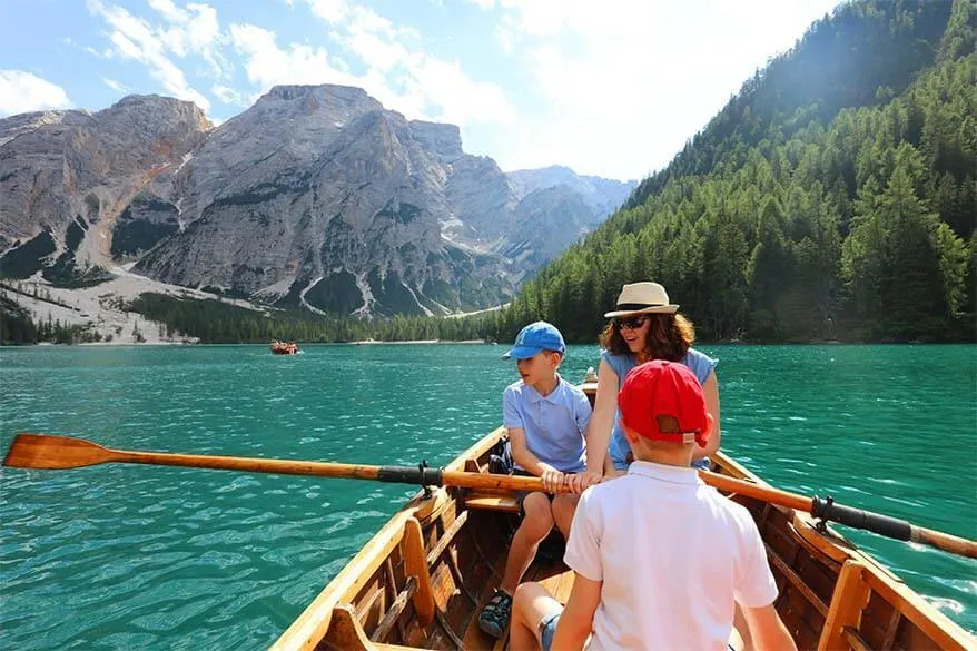 Family rowing a boat on Lago di Braies in Italy