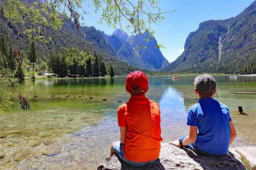 Kids enjoying the view at Lago di Dobbiaco in the Italian mountains