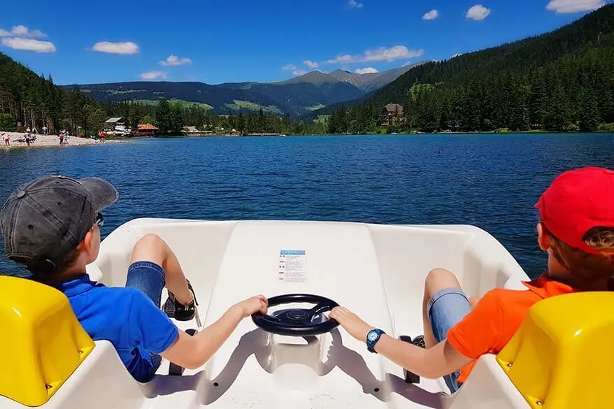 Kids on a peddle boat on Lake Dobbiaco in Italy