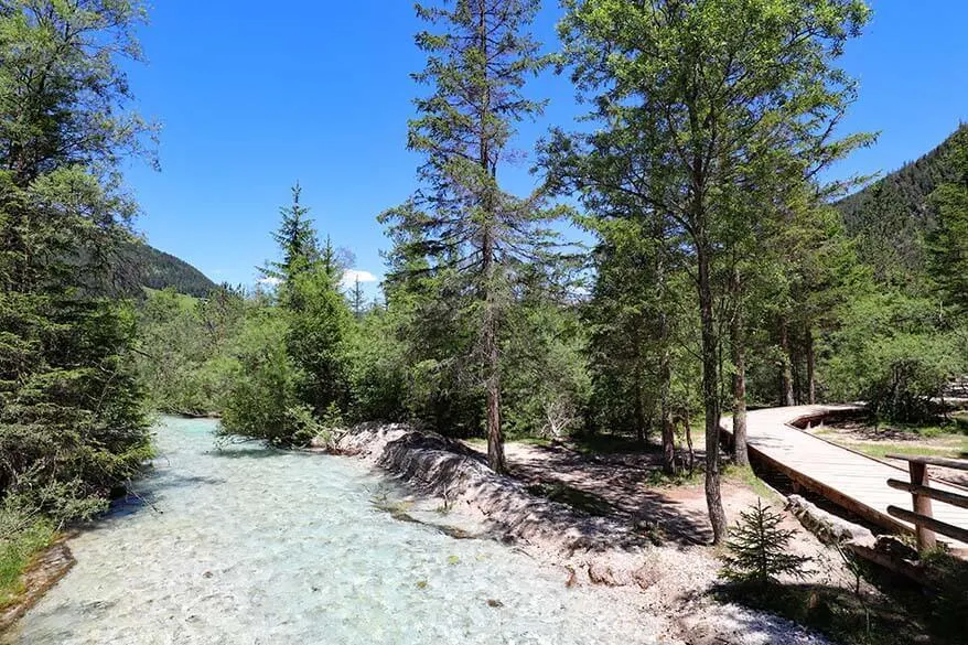 Mountain river and hiking trail at Lago di Dobbiaco