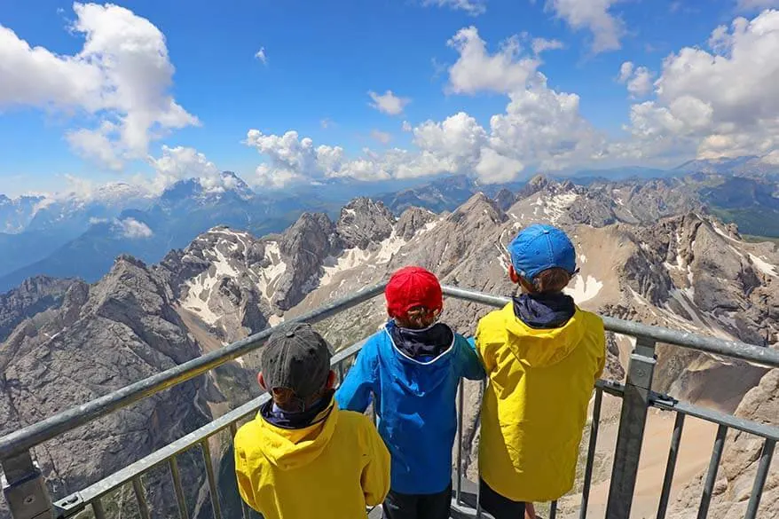 Kids admiring mountain scenery at Marmolada in Italian Dolomites