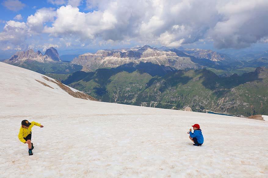 Kids playing on the snow on Marmolada glacier in summer